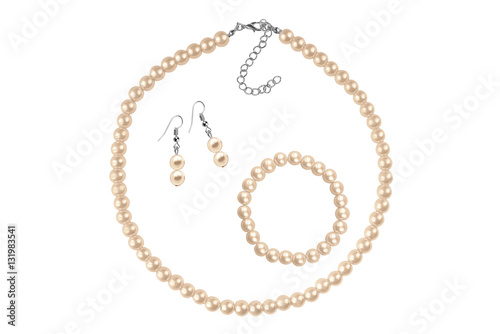 Fashion set of a necklace, a bracelet and a pair of earrings made of bronze medium-sized round beads like pearls, fashion isolated on white background, clipping path included