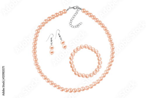 Fashion set of a necklace, a bracelet and a pair of earrings made of intensive red medium-sized round beads like pearls, fashion isolated on white background, clipping path included