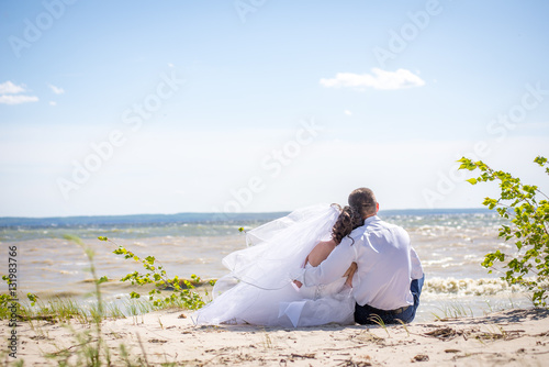 Couple sitting on the beach.