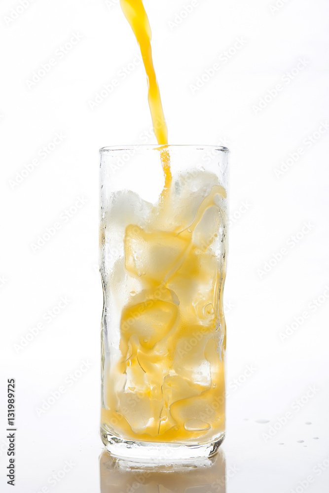 Pouring Orange Juice to the ice glass Pouring Orange Juice to the ice glass