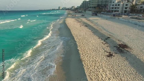 Aerial footage of Cancun beach. Drone flying above shore line with hotels
