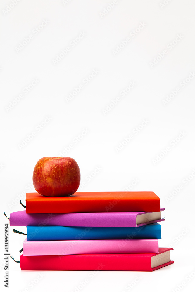 Colorful stack books with a fresh apple isolated 