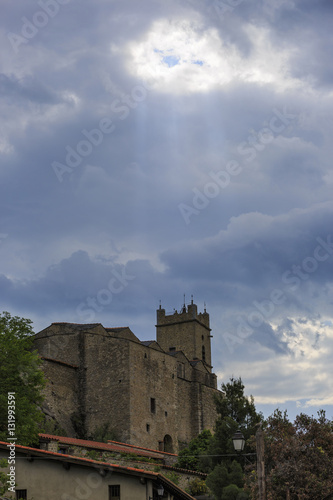 God rays over the Church of Saint-Vincent, Eus, France
