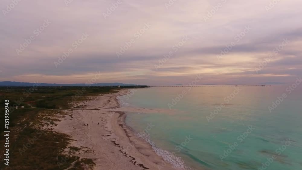 Aerial shot, marvellous white beach on the sunset with beautiful clouds and very calm sea Aerial shot, marvellous white beach on the sunset with beautiful clouds and very calm sea
