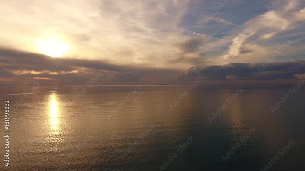 Aerial shot, incredibly beautiful calm sea in the sunset light with lots of clouds Aerial shot, incredibly beautiful calm sea in the sunset light with lots of clouds