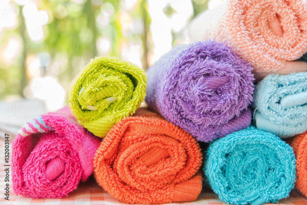 Roll of Multicolor towels on table cloth with nature blur background Roll of Multicolor towels on table cloth with nature blur background