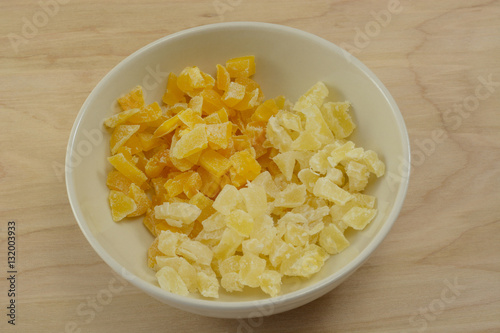 Chopped dried mango and pineapple pieces in white bowl