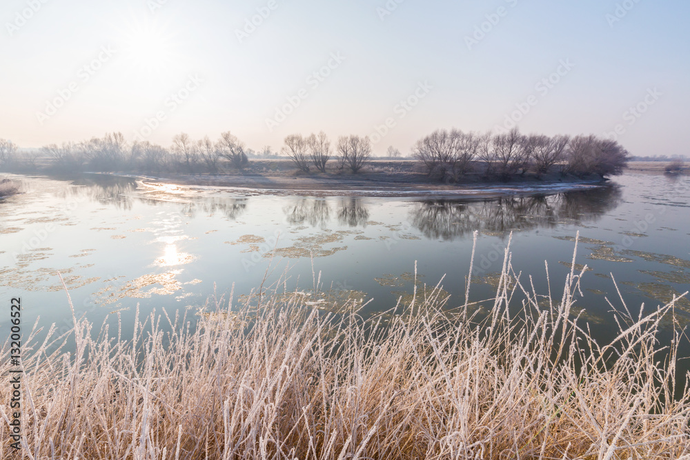 Winter scenery, with frozen river and frost cover vegetation on a cold, sunny, day Winter scenery, with frozen river and frost cover vegetation on a cold, sunny, day