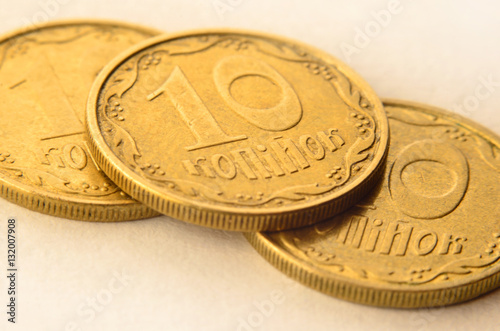 Detailed macro shot of Ukrainian money coins in the form of cash cents. Ukrainian kopeck with detailed metal texture and relief ornament in the form of plants.