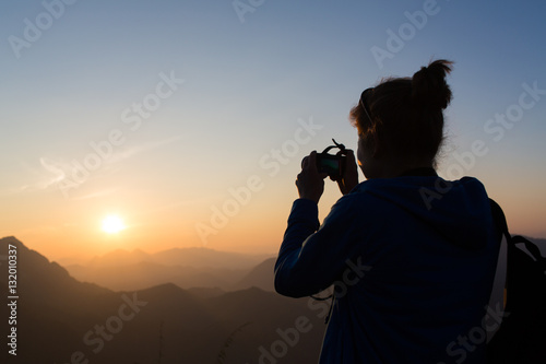 Hiker try to get picture on mobile phone,sunrise from Nong Khiaw village viewpoint