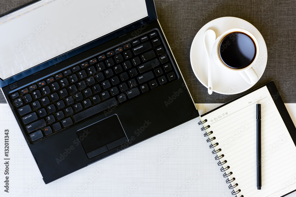 Laptop , notebook and cup of coffee on working table, top view Laptop , notebook and cup of coffee on working table, top view