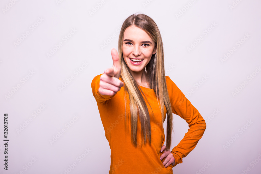 Happy blonde girl in orange t-shirt pointed on you on white Happy blonde girl in orange t-shirt pointed on you on white