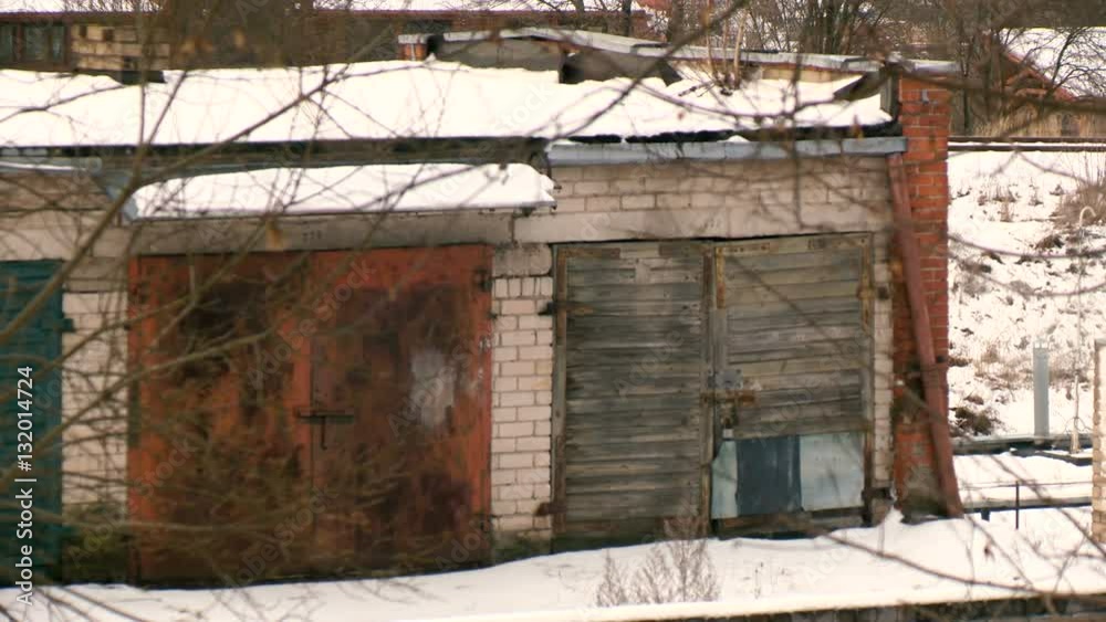Old soviet style garages under the trees in winter. Old soviet style garages under the trees in winter.