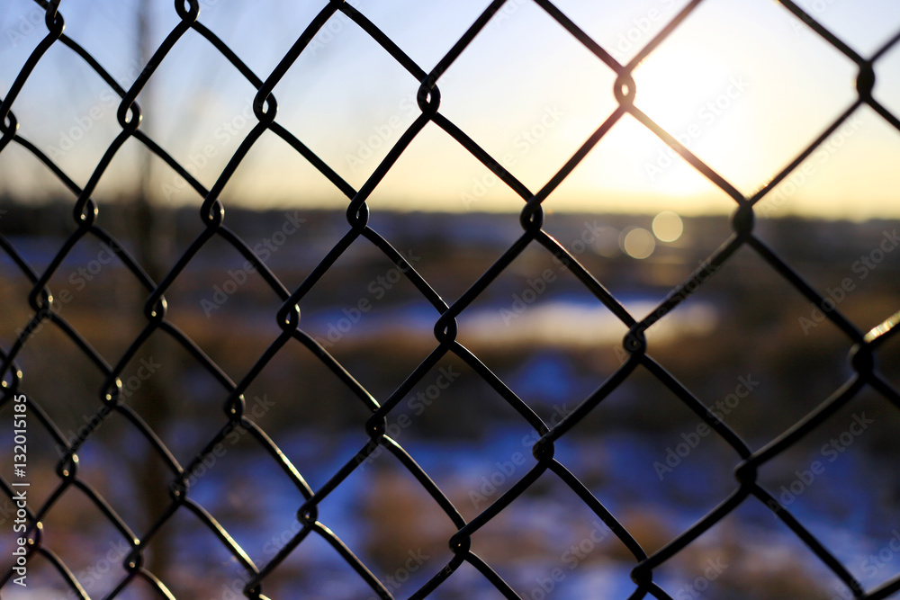 wire mesh fence in sunset background