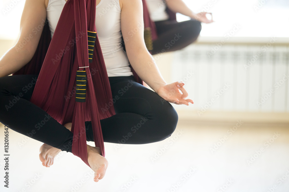 Φωτογραφία Young beautiful yogi woman doing aerial yoga practice in purple hammock in fitness club