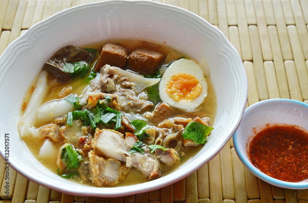 boiled Chinese pasta with pork and entrails topping creamy egg yolk in soup boiled Chinese pasta with pork and entrails topping creamy egg yolk in soup