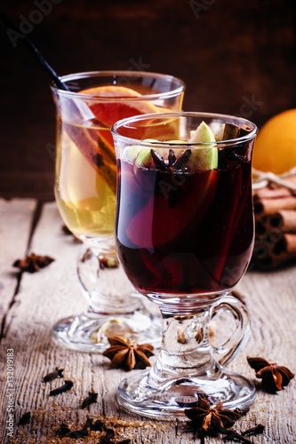 Hot mulled wine with white and red dry wine, spices and fruits,