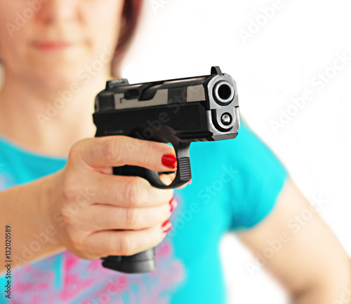 hand gun pistole in a woman hand