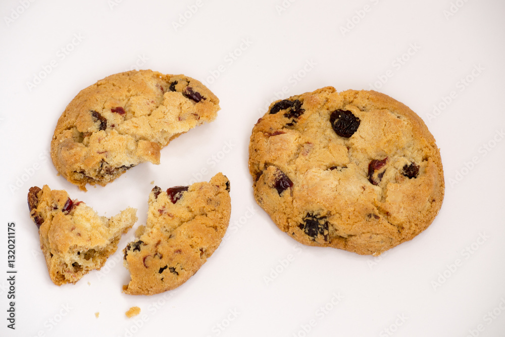 Two cookies with raisins broken into pieces. Two cookies with raisins broken into pieces.