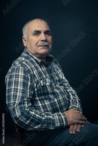 Thoughtful middle aged man in check shirt
