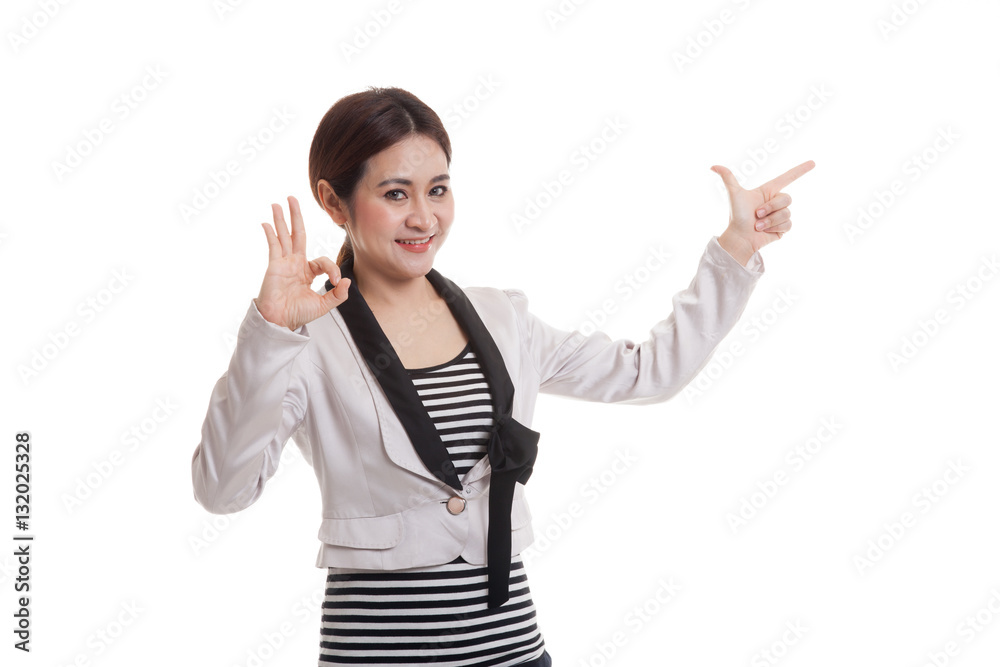 Young Asian business woman point and show OK. Young Asian business woman point and show OK.