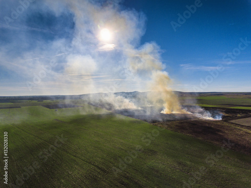 Aerial view of fire on autumn field