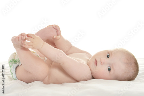 Baby girl lying on blanket