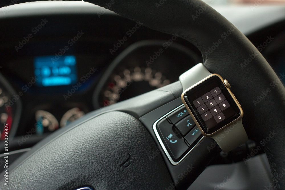 Modern car interior with smart watch on steering wheel