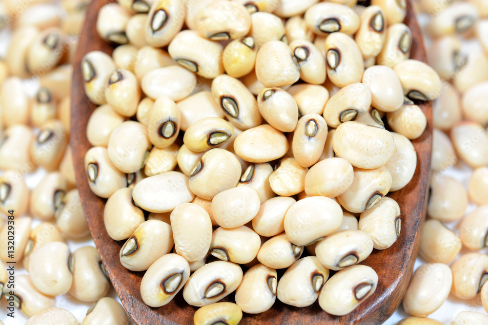 Black eyed pea on a wooden spoon.