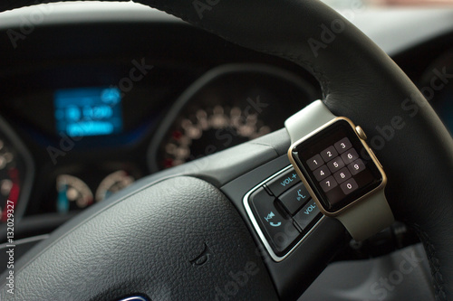 Modern car interior with smart watch on steering wheel © PaulShlykov