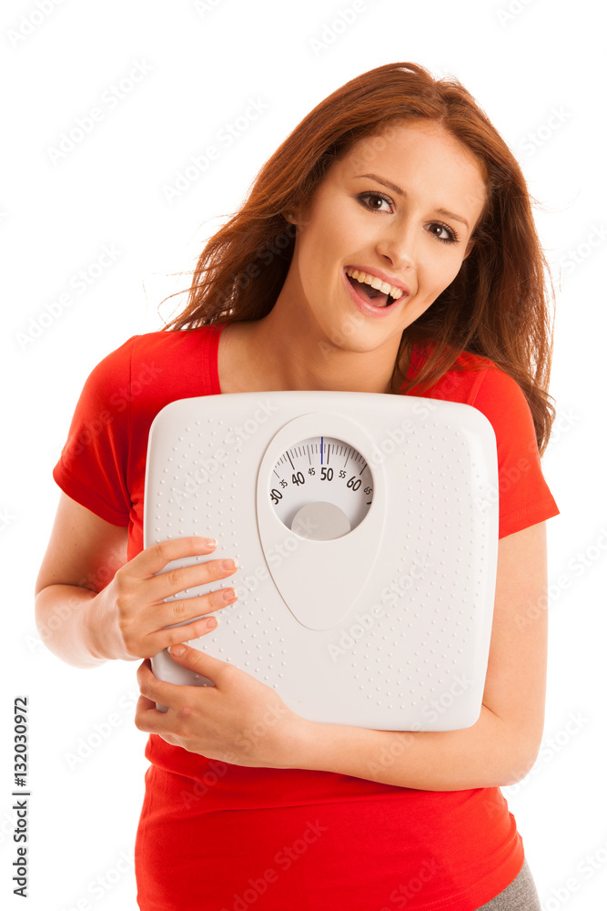 Woman with scale happy with her weight isolated over white backg Woman with scale happy with her weight isolated over white backg
