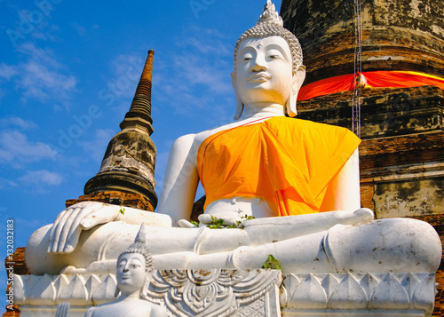 White old buddha statue with blue sky background at Wat Yai Chai Mongkhon Old Temple in Ayutthaya Historical Park Thailand.