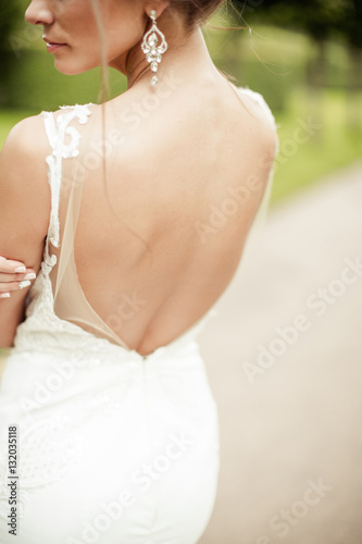 beautiful young bride standing in a park 