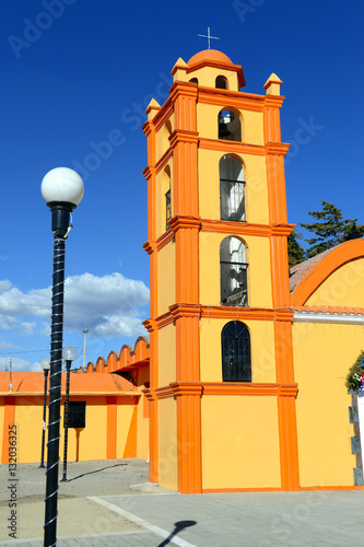 Colorful Church with blue sky background located near borders of Veracruz and Puebla, close to Pico de Orizaba, Iztaccihuatland Popocatepetl volcanoes, Mexico photo