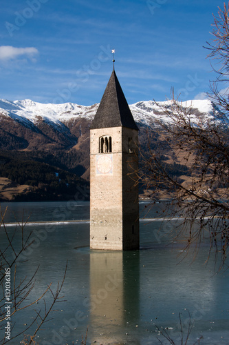 Sunken church tower at frozen lake resia, Italy