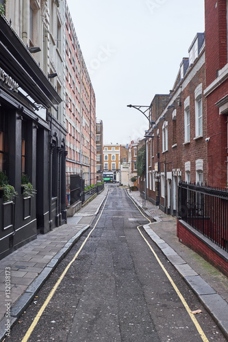 A look down Conduit Place, a narrow alley with highrise and low residential buildings