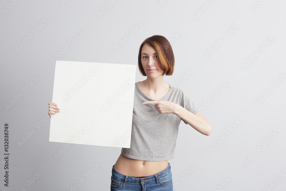 Beautiful caucasian girl holding a blank poster for text or ad.