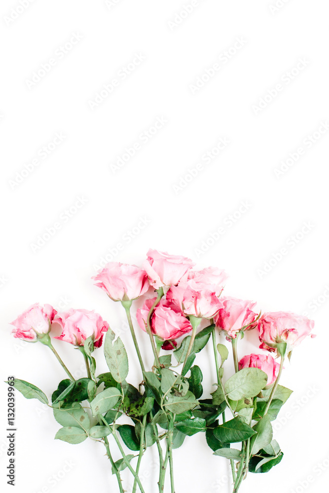 Pink roses bouquet on white background. Flat lay, top view. Valentine's background.