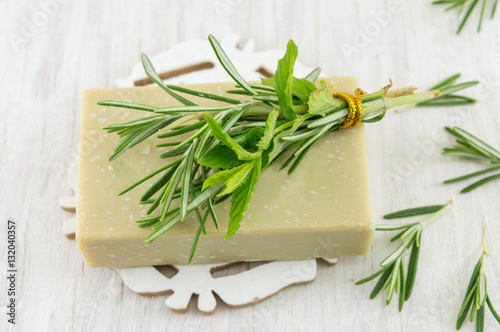 Herbal soap with rosemary and mint leaves