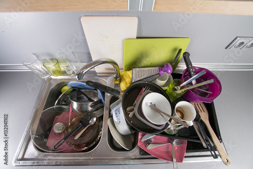 Dirty dishes in a kitchen sink. 