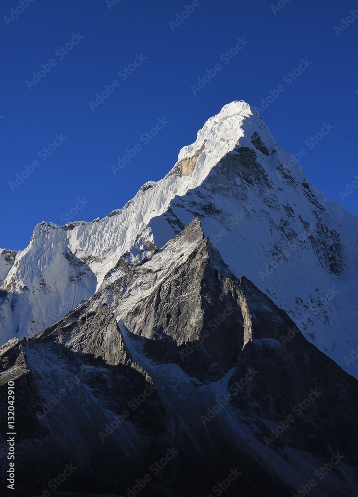 Pointed mt Ama Dablam and azure blue sky