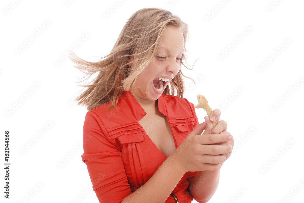 Obraz premium Teenage girl fights with toy snake, simulating the fear of a snake