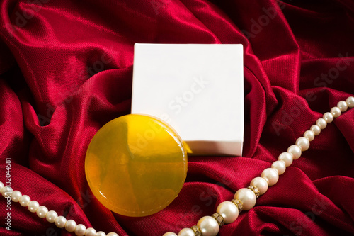 soap and box on red fabric background