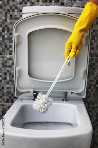 cleaning of white toilet bowl