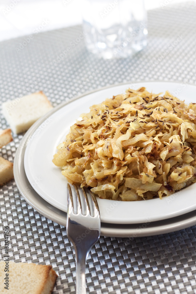Fried cabbage with caraway and garlic on a plate Fried cabbage with caraway and garlic on a plate