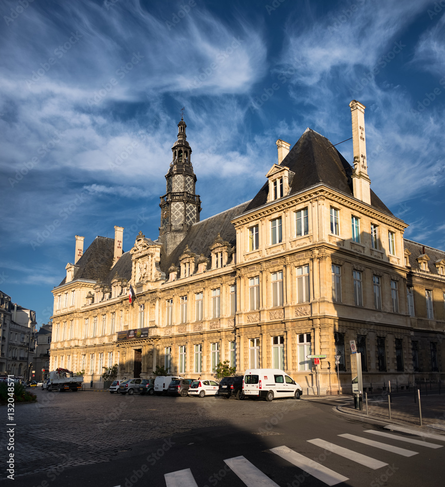 Lateral view on Reims town hall in sunlight, France