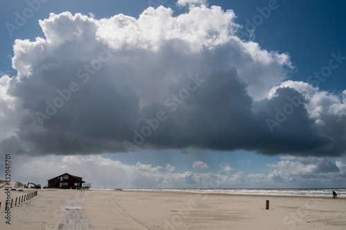 Big cloud hovering over the beach.