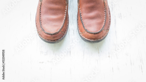 Men's fashion with brown leather shoes with space on white wooden background