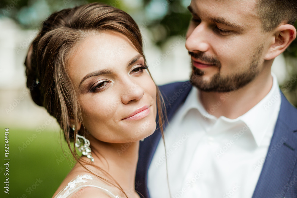 Young wedding couple enjoying romantic moments outside on a summer meadow Young wedding couple enjoying romantic moments outside on a summer meadow