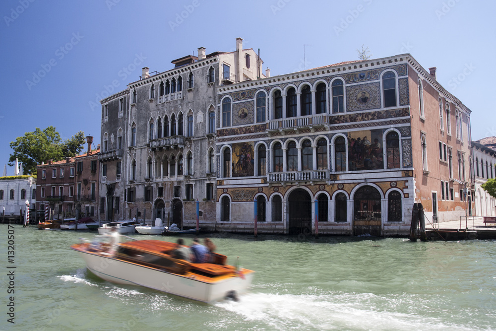 Obraz premium Medieval palazzos (palaces) on Grand Canal in Venice with taxi boat in front
